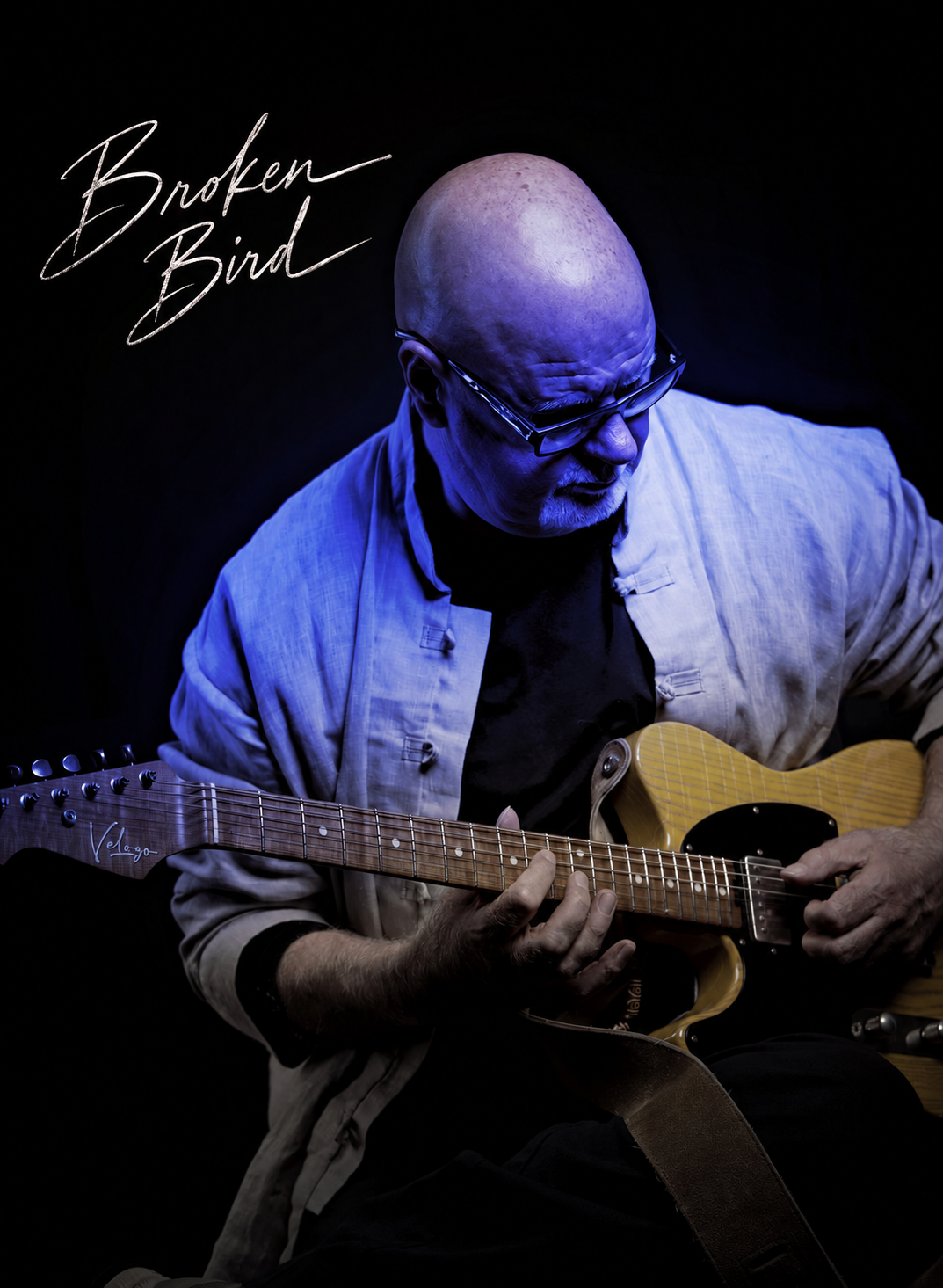 Broken Bird musician playing guitar in electric blue light